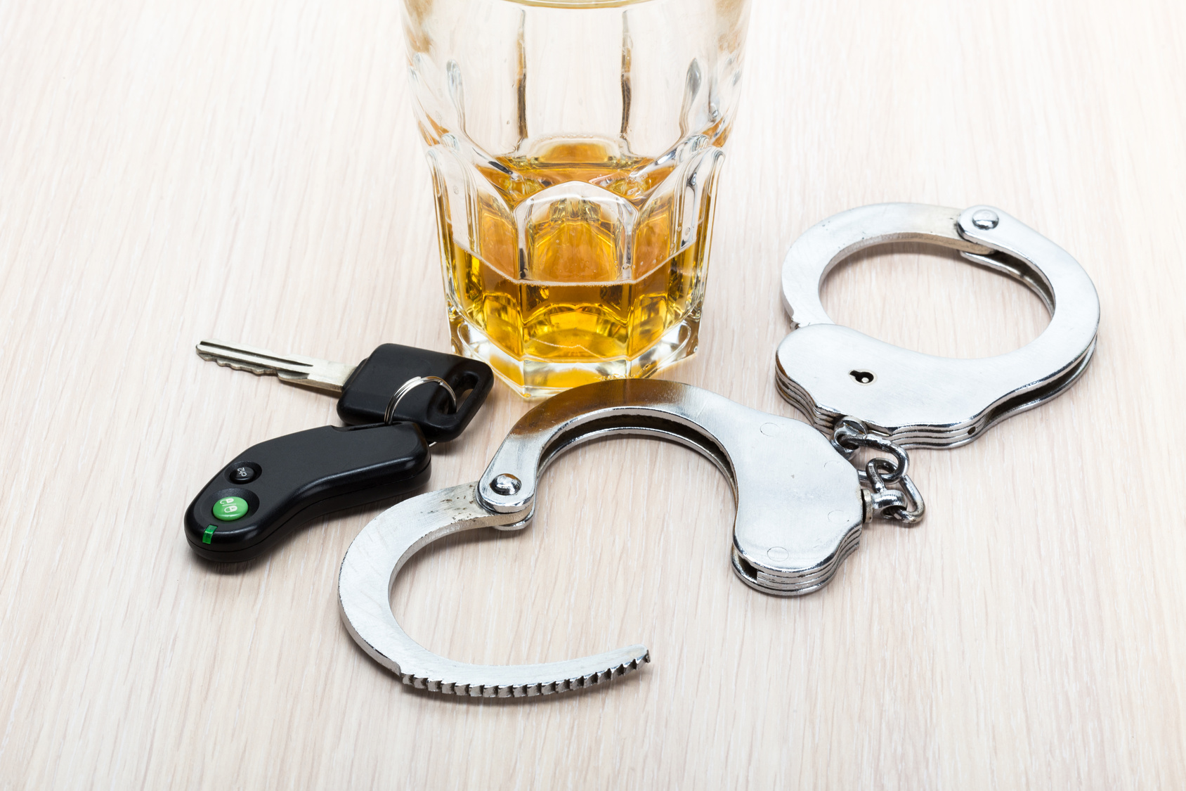 Car key on the bar with spilled alcohol